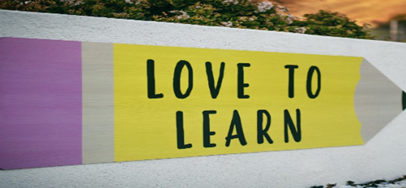 An image of sign with the words 'Love to Learn' written on, along with the image of a pencil.