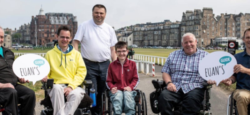 Euan's Guide Ambassadors, team members and users pictured together holding Euan's Guide signs