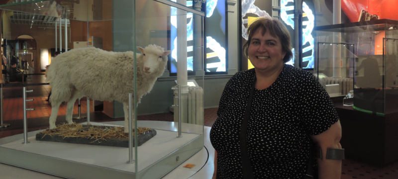 Dolly the Sheep in a glass case at The National Museum of Scotland, Tina is pictured on the right standing next to the exhibit.