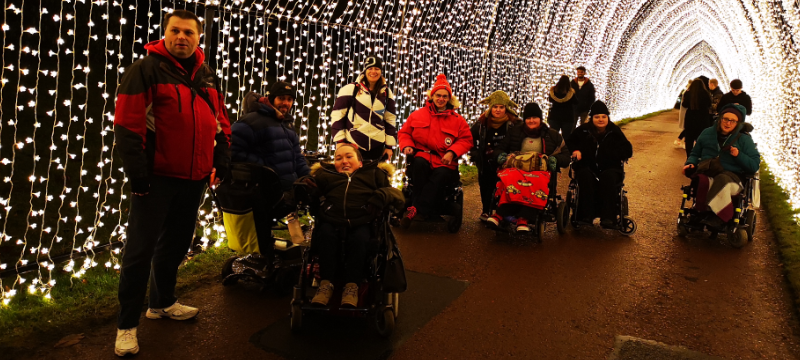 A group of people under a tunnel of lights.