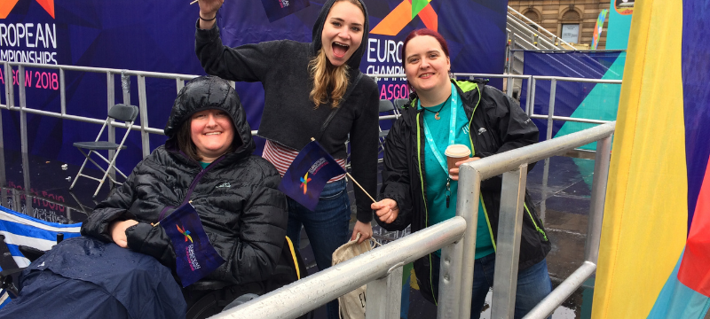 A group picture taken at the 2018 European Championships. Karine is on the left with her hood up.