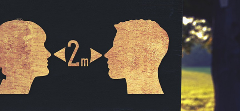 Image of a sign with silhouettes of a woman and a mans face with the text 2 m in between them