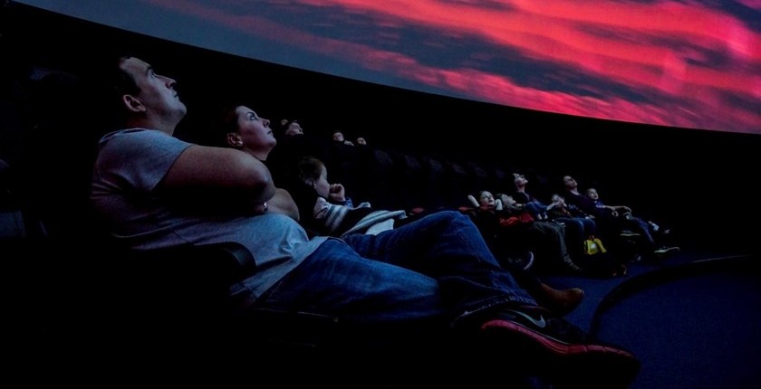 People looking above at the Glasgow Science Centre 'Planetarium'.