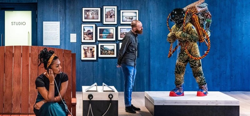 Two people using and viewing exhibitions at Wellcome Collection in London.