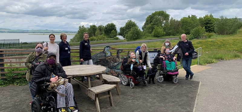 Euan's Guide team members and Ambassadors in a group outside the visitor centre at RSPB Loch Leven