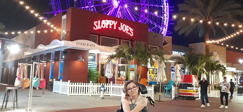 Jill sitting in her Wheelchair outside Sloppy Joes Restaurant