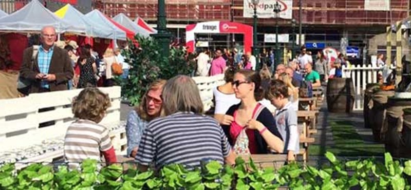A photo of people in an outdoor bar. 