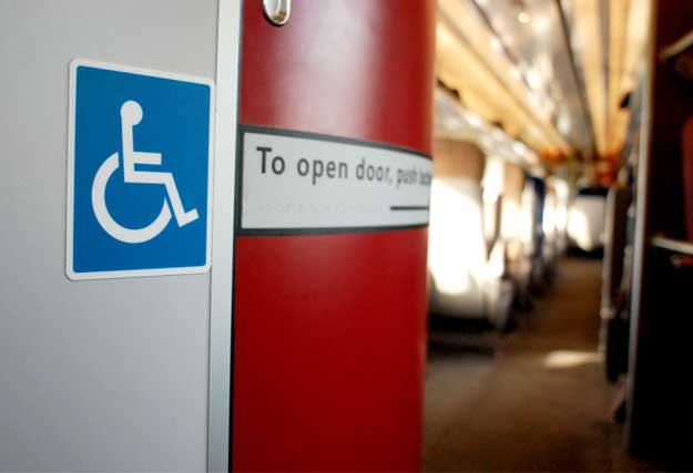 A photo of a sign for an accessible toilet on a train
