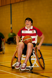 A photo of a wheelchair user playing basketball 