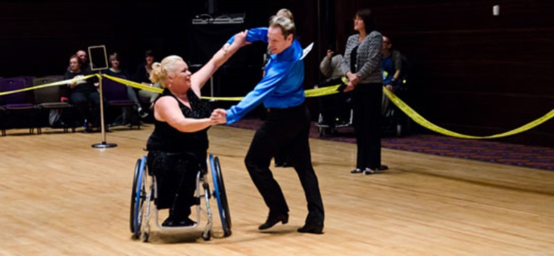 Two people dancing in a competition. 