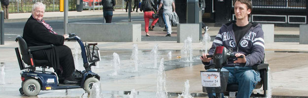 A photo of two people beside a water fountain.