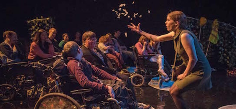 Photo of a performer in front of an audience of children.