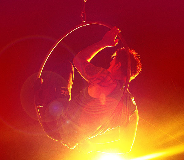 Photo of acrobat in a hoop suspended in mid air