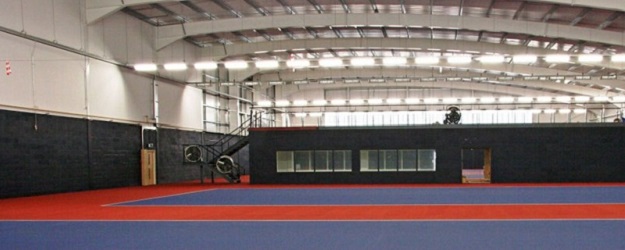 Photo of an indoor tennis court.