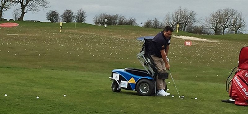 Photo of Anthony Netto using the paragolf machine.