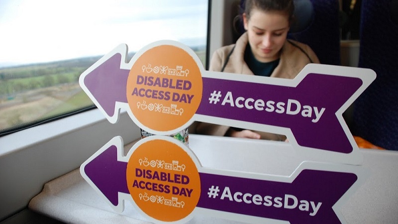 Photo of Olivia and Disabled Access Day arrows.