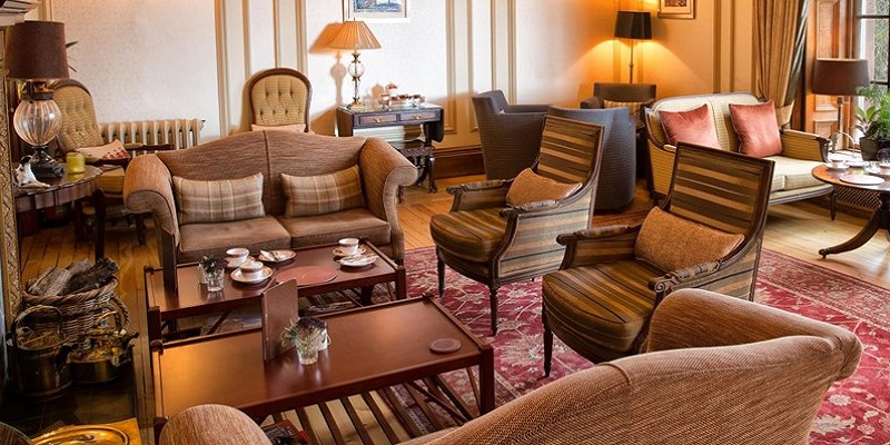 Image of inside Cringletie house hotel. It shows a room with lots of comfy seating options.