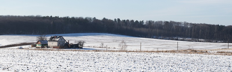 Photo of a rural cottage in the snow.