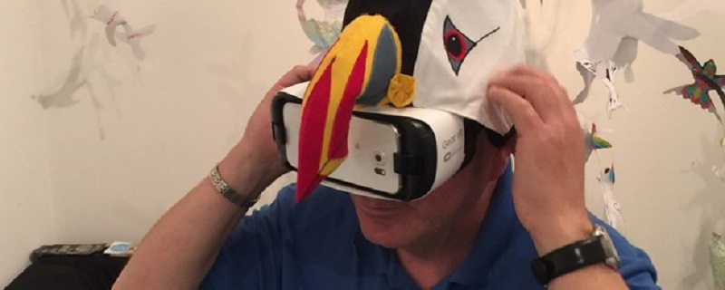 Photo of a person trying on a virtual reality headset.
