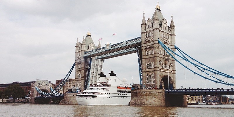 Photo of the Tower Bridge with a boat passing under.