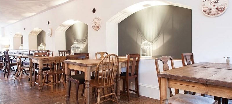 Photo of wide spaces between restaurant furniture.