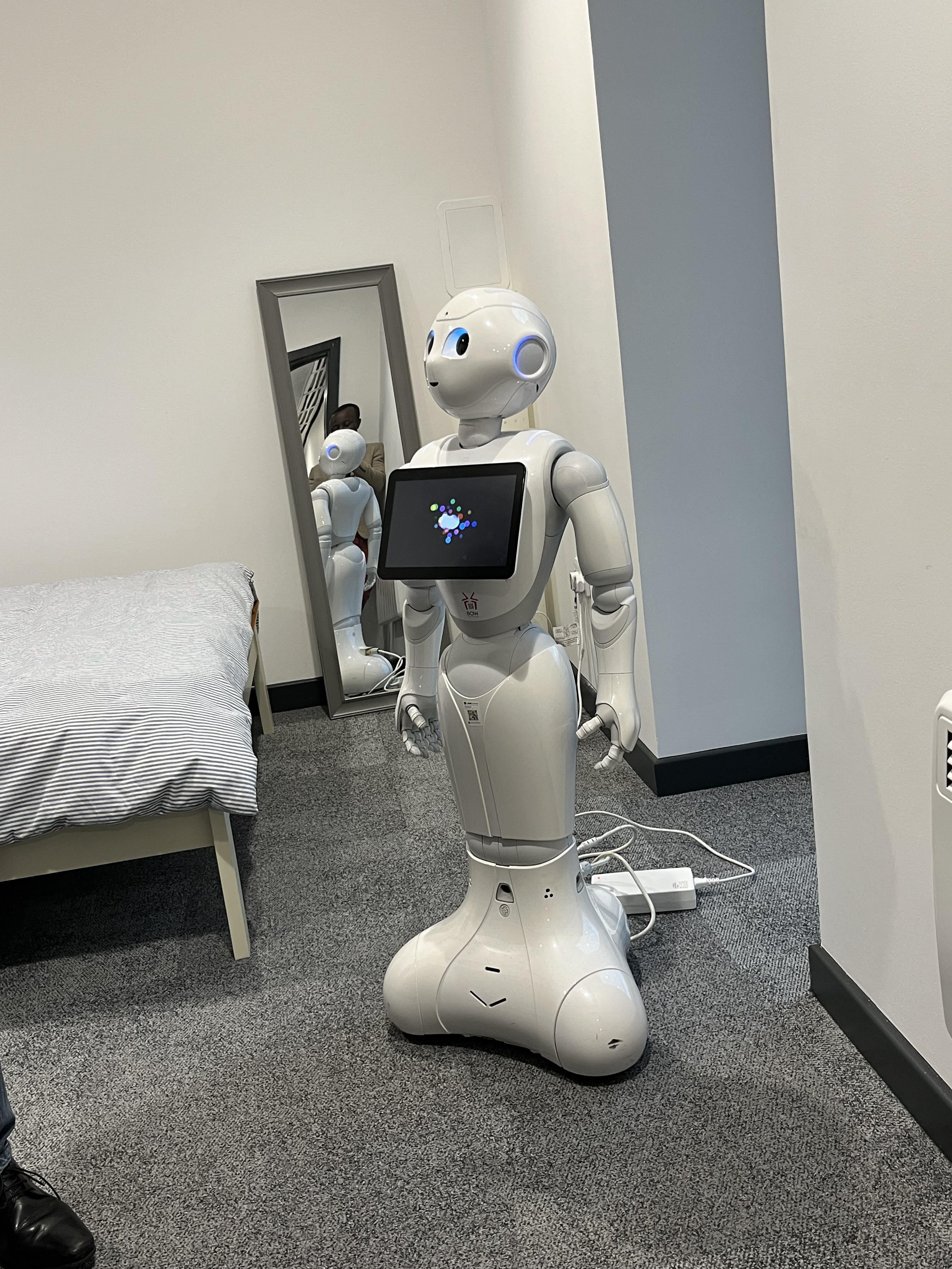A standing robot with a tablet / screen on the chest