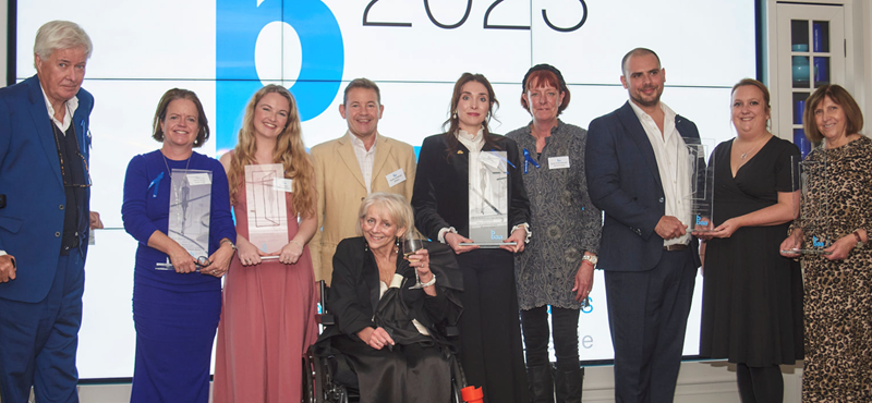 A photograph of award winners receiving their award on stage at the Blue Badge Access Awards 2023