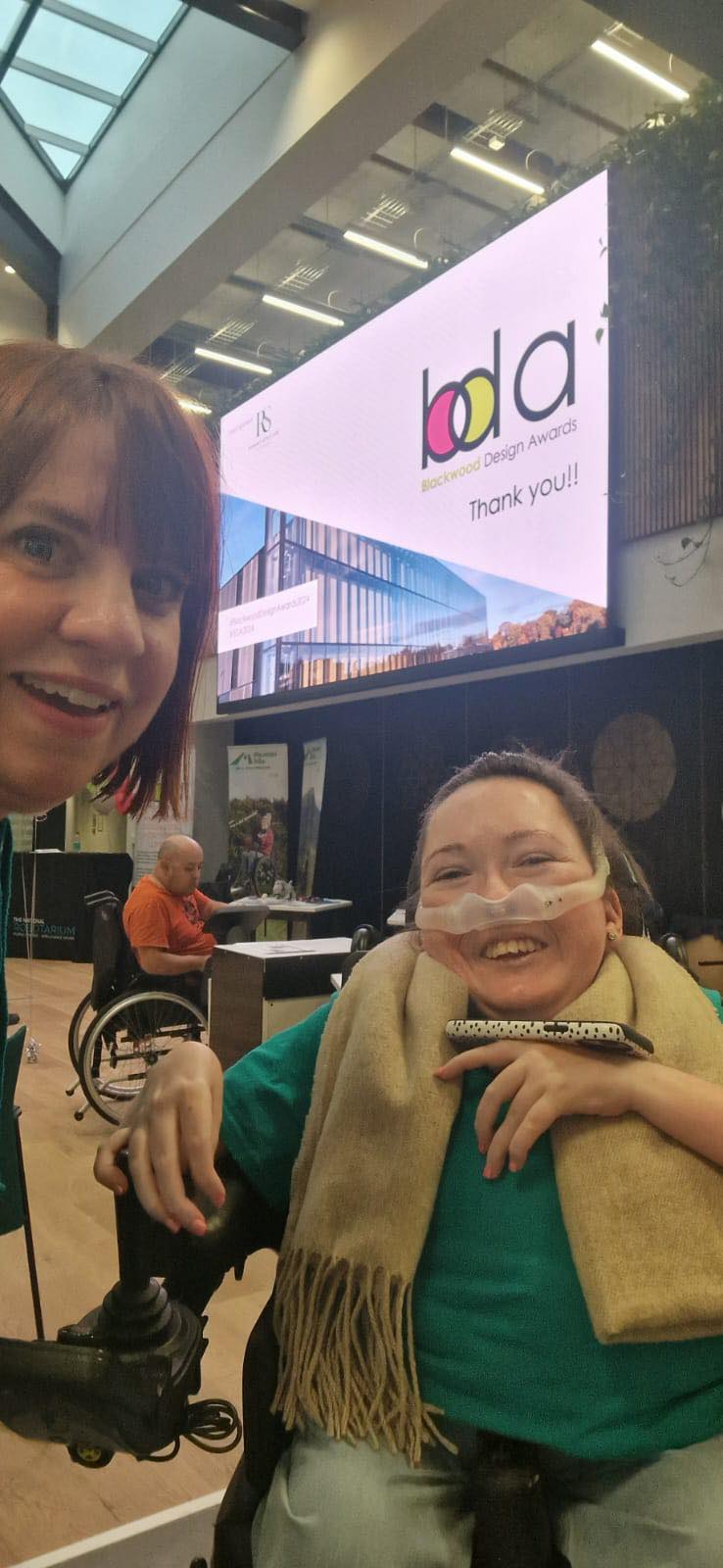 A selfie of Juile and Claire in front of the Blackwood Design Awards branded screen