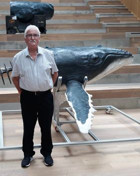 A photo of George with the robot whale used in the BBC programme Spy in the Ocean