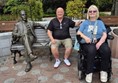 Image of two people and a statue