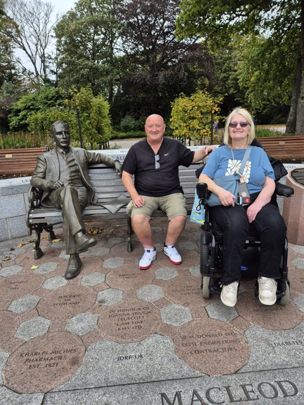 Image of two people and a statue