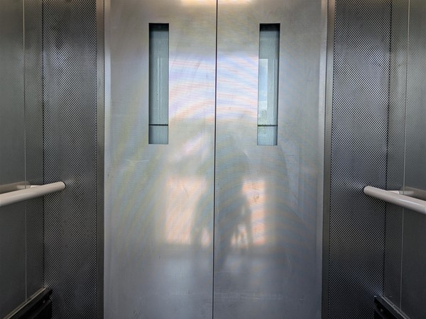 Image of doors inside lift, there are rails on either side too