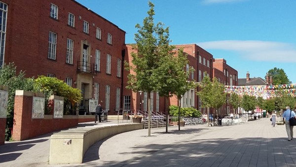 Entrance to the university union, there is a ramp or a set of stairs with hand rails