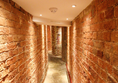 Narrow brick corridor, well lit