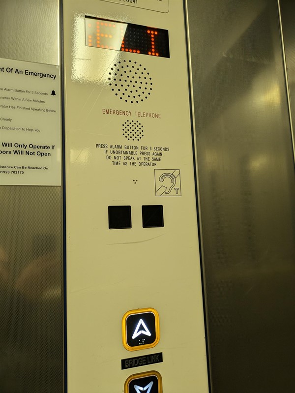 Image of button panel in the lift. The lift buttons have braille markings