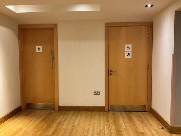Picture of the toilet doors with the accessible toilet on the right