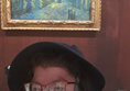 Image of a person in front of a painting