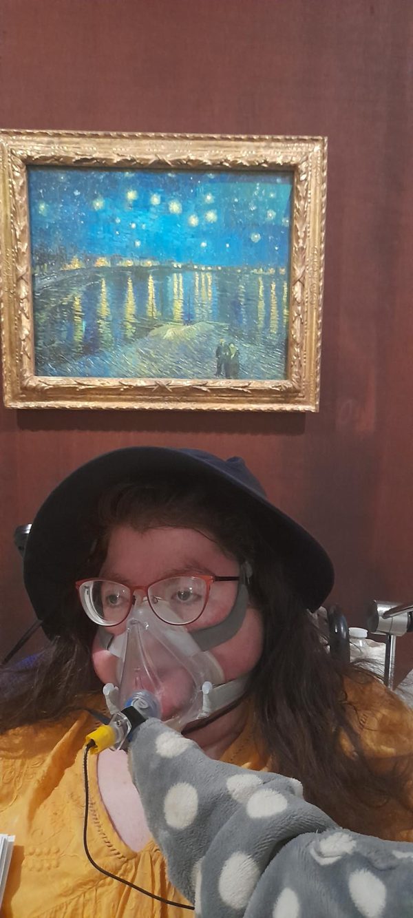 Image of a person in front of a painting