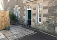 Image of reviewer going through accessible entrance.