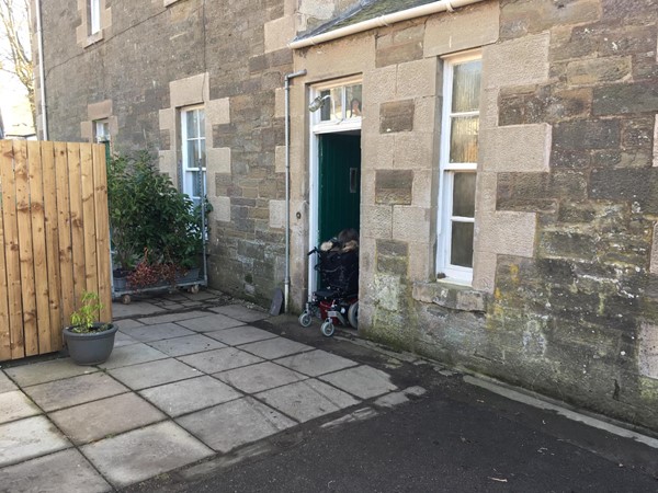 Image of reviewer going through accessible entrance.