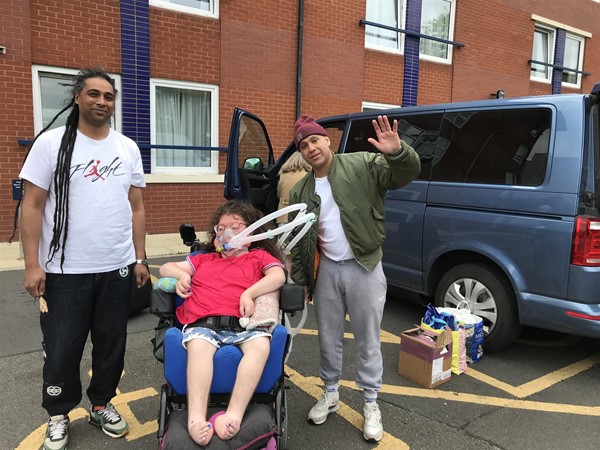 Image of three people and a van