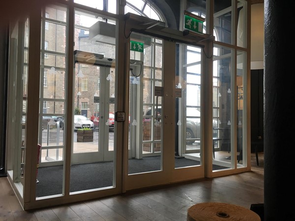 Image of the doors from the inside showing the automatic button to open them.