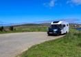 Car park with no spaces marked and just a motorhome parked up.