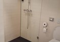 One of the hotel bathrooms with shower adn toilet.  See the short step into the shower.