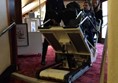Stair climber being used. The figure in the chair is me and the staff pictured have given consent to use all attached photos