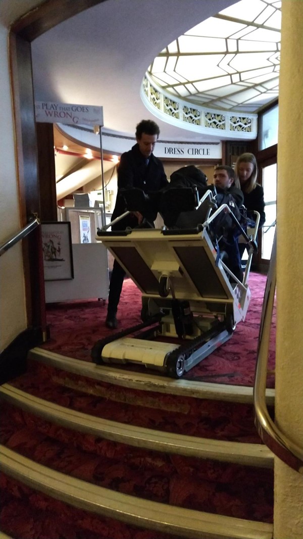 Stair climber being used. The figure in the chair is me and the staff pictured have given consent to use all attached photos