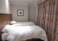 Two single beds. Not much space to walk to the far bed.