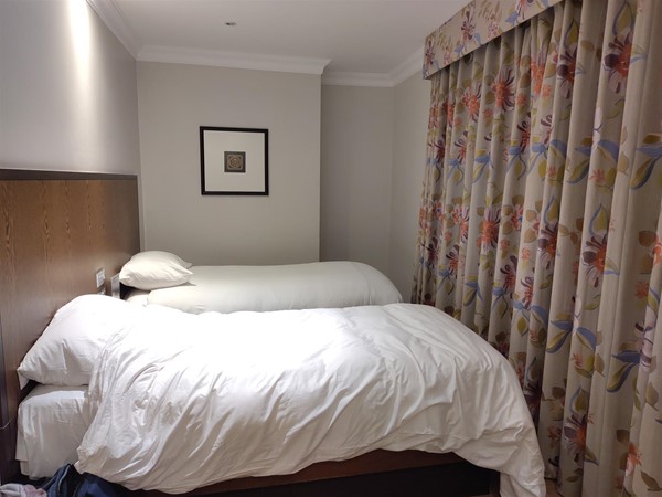 Two single beds. Not much space to walk to the far bed.