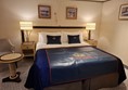 There was space to drive my wheelchair alongside the right hand side of the bed. The small table rises and falls using an under top hand rail. The plastic may I the bed is for suitcase use