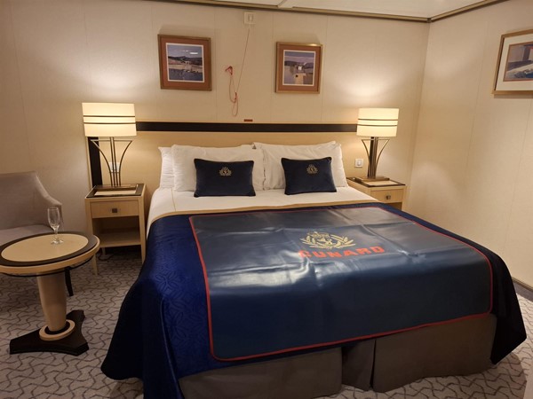 There was space to drive my wheelchair alongside the right hand side of the bed. The small table rises and falls using an under top hand rail. The plastic may I the bed is for suitcase use
